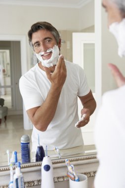 Man Shaving In Bathroom Mirror clipart