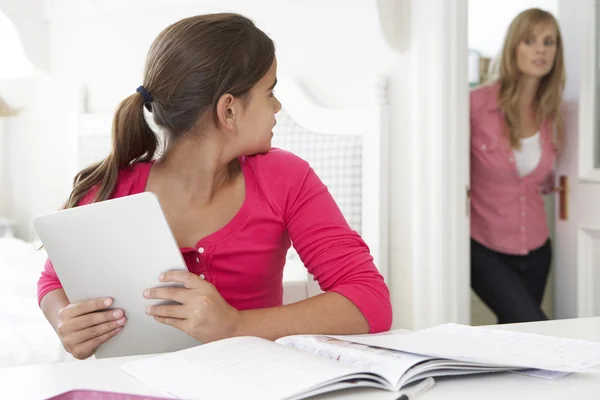 Mother Catches Daughter Using Digital Tablet — Stockfoto