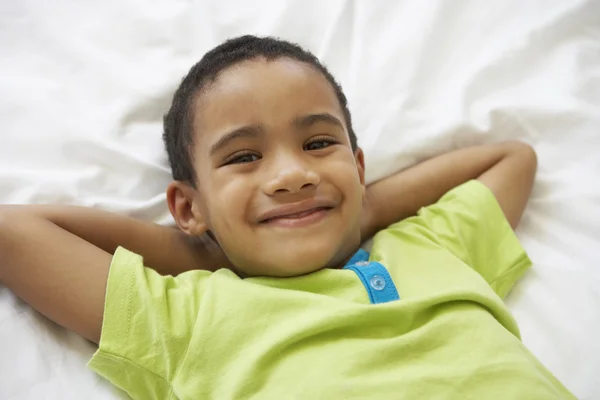 Young Boy Relaxing On Bed — Stock Photo, Image