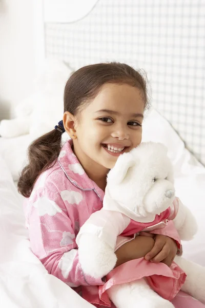 Young Girl in Pajamas With Cuddly Toy — Stock fotografie