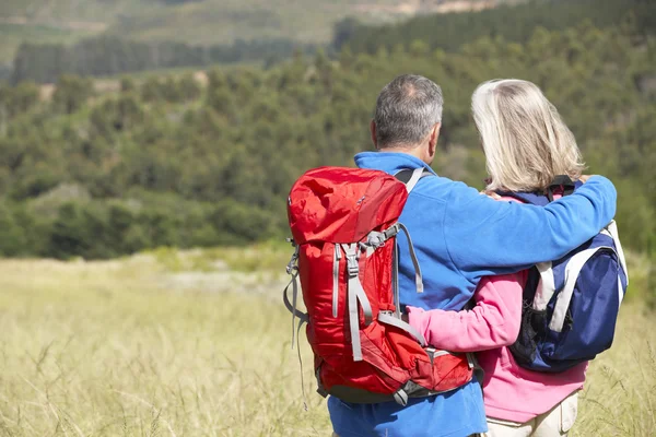 Pareja mayor en caminata por el campo — Foto de Stock