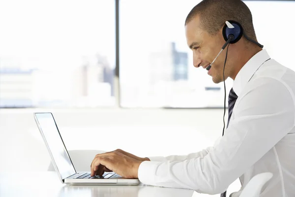 Businessman Wearing Headset and Using Laptop — Stock Photo, Image