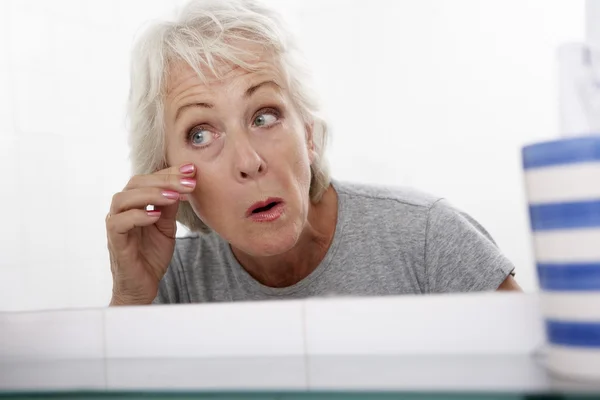 Senior paar vrouw spiegel kijken — Stockfoto