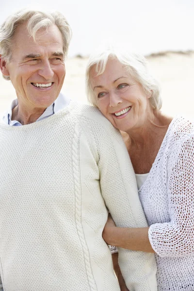 Senior paar wandelen langs strand — Stockfoto