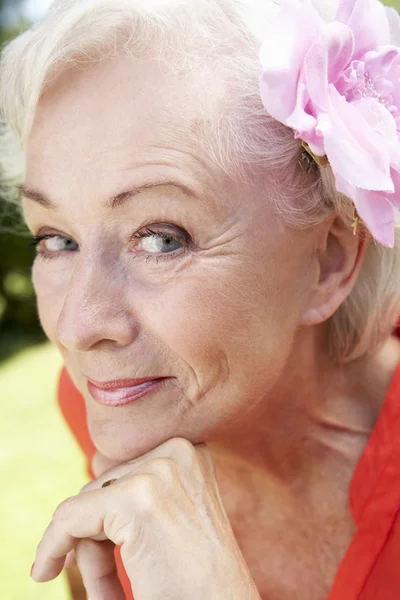 Smiling Senior Woman With Flower Stock Picture