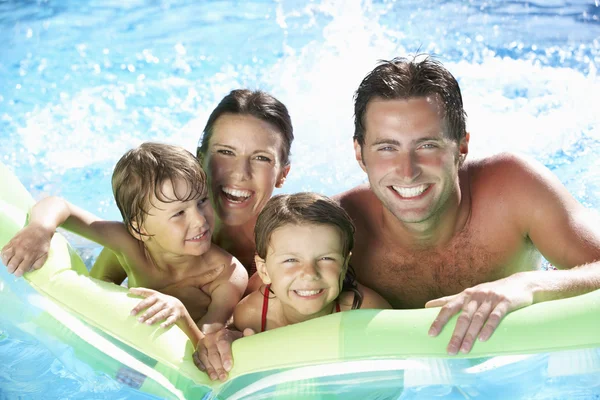 Family On Holiday In Swimming Pool Royalty Free Stock Photos