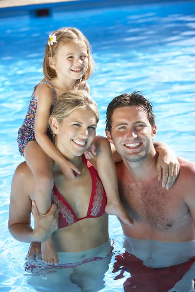 Family On Holiday In Swimming Pool Stock Image