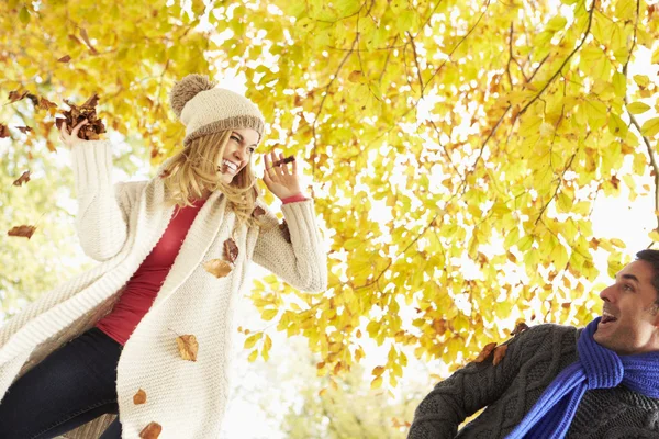 Casal jogando folhas no jardim — Fotografia de Stock