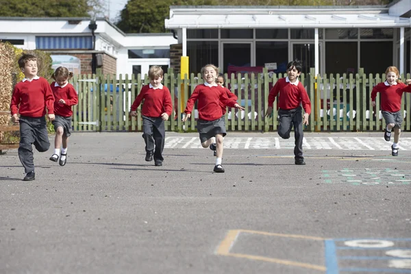 Elementary School Pupils Running In Playground — Stock Photo, Image