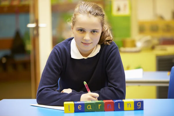Word "Learning" In Blocks With Pupil Behind — Stock Photo, Image