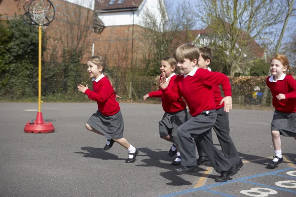 Elementary School Pupils Running In Playground — Stock Photo, Image