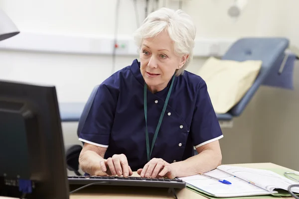 Krankenschwester arbeitet am Schreibtisch im Büro — Stockfoto