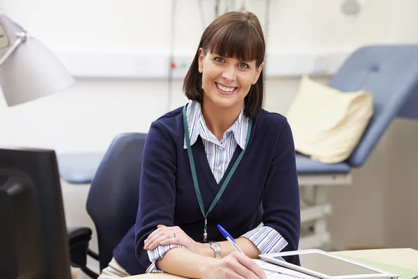 Consultant Working At Desk In Office Stock Picture