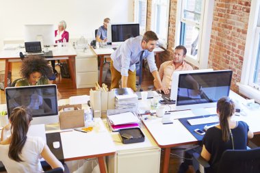 Busy Design Office With Workers At Desks clipart