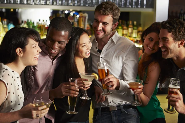 Group Of Friends Enjoying Drink In Bar Stock Image