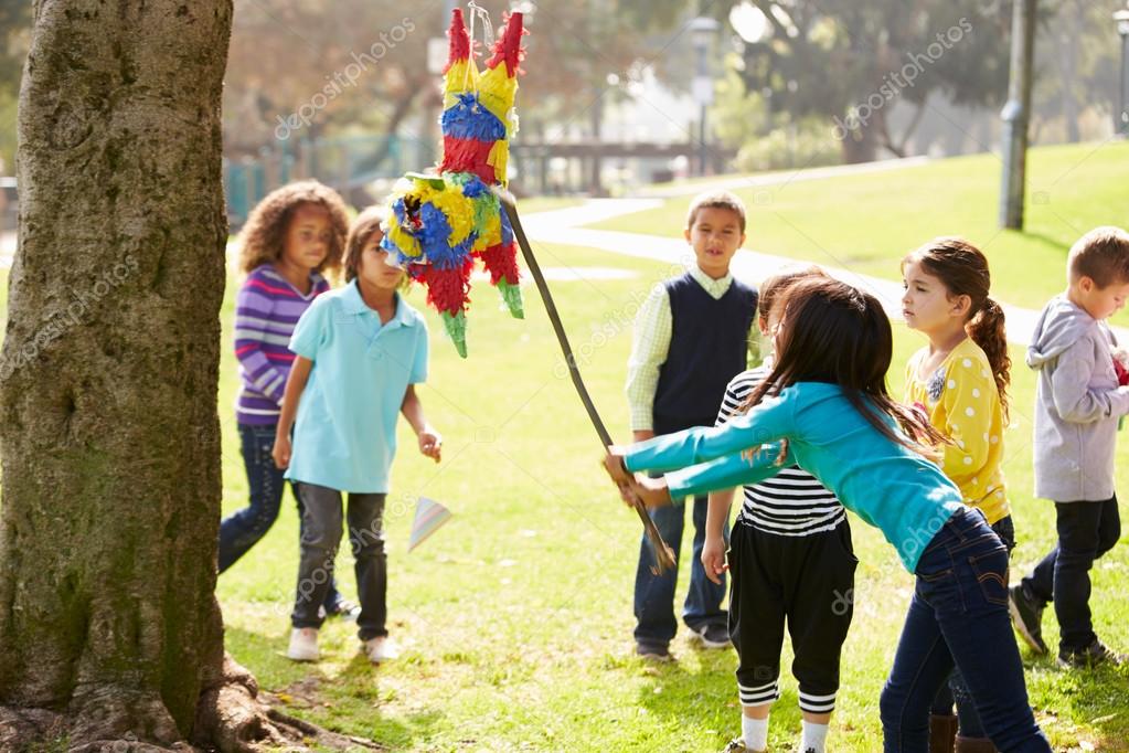 Children Hitting Pinata At Birthday Party — Stock Photo © monkeybusiness  #102796138