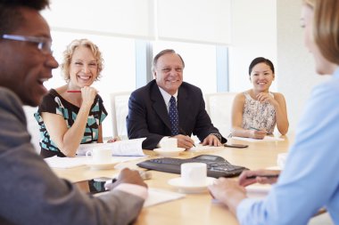 Businesspeople Having Meeting In Boardroom clipart