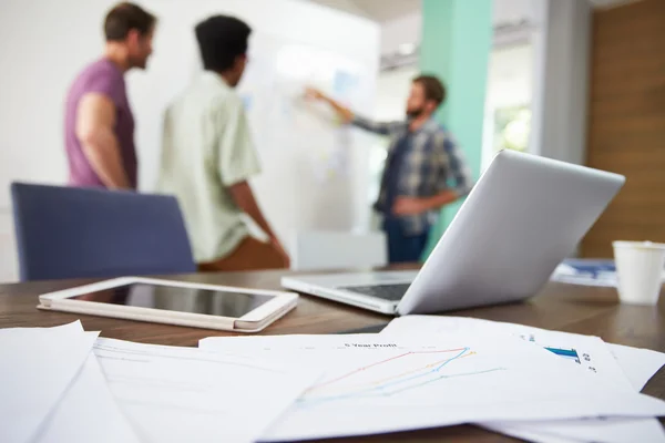 Documents And Laptop With Meeting In Background — Stock Photo, Image