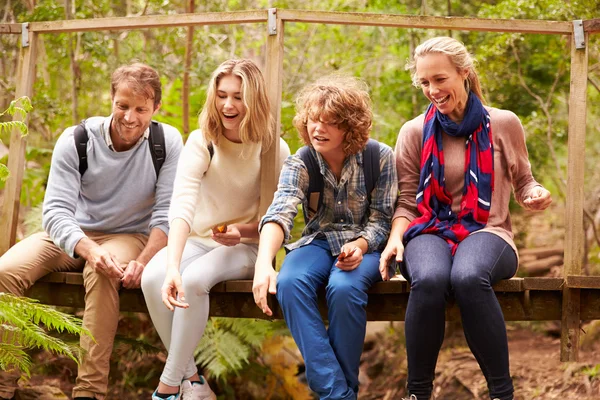 Parents and teens in forest