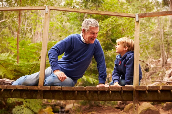 Grandfather with grandson in forest — Stock Photo, Image