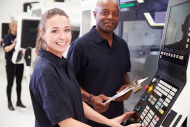 Apprentice Working With Engineer On CNC Machine clipart