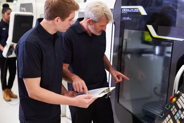 Aprendiz trabajando con ingeniero en maquinaria CNC — Foto de Stock