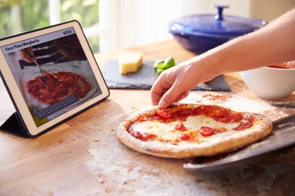 Following Pizza Recipe On Digital Tablet