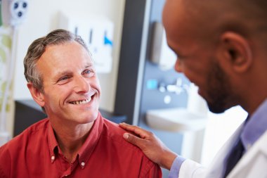 Male Patient Being Reassured By Doctor clipart