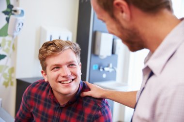 Male Patient Being Reassured By Doctor clipart