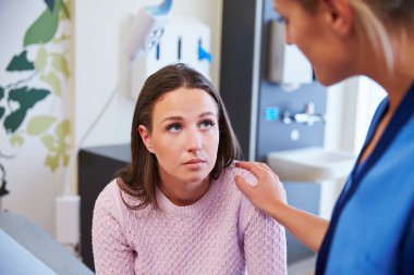 Female Patient Being Reassured By Nurse clipart