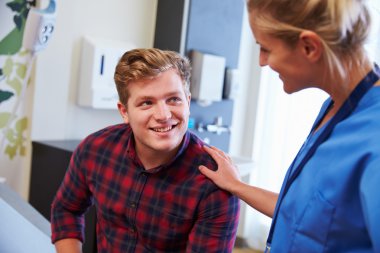 Male Patient Being Reassured By Nurse clipart