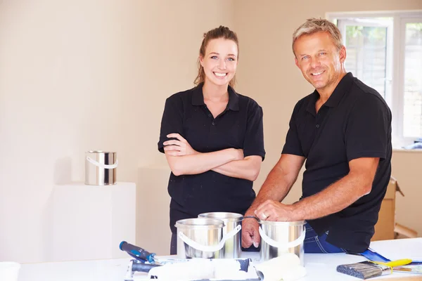 Smiling male and female decorators — Stock Photo, Image