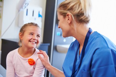 Girl Being Reassured By Nurse In Room clipart