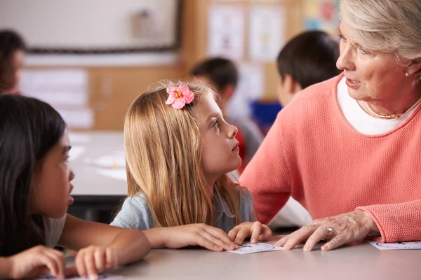 Professora sénior ajuda alunos — Fotografia de Stock