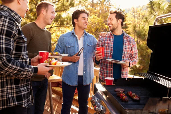 Group Of Gay Friends Enjoying Barbeque