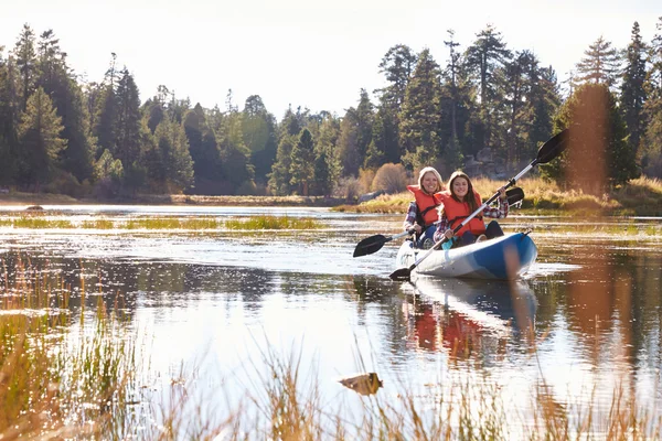Mother and daughter kayaking on lake Stock Photo