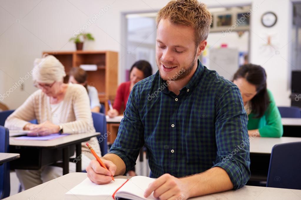 Man studying at an adult education class - Stock Photo, Image. 