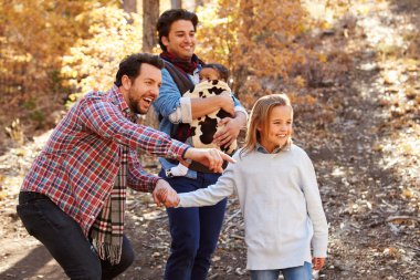 Male Couple With Children Walking in Woodland clipart