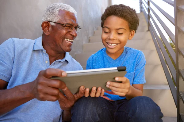 Close Grandfather Grandson Seitting Steps Outdoors Home Using Digital Tablet — Stock fotografie