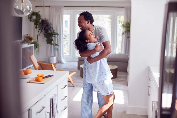 Loving Couple Wearing Pyjamas Hugging Kitchen Home Together — Stock Photo, Image