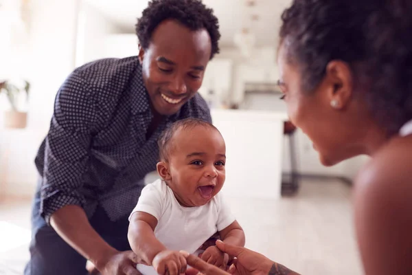 Ouders Moedigen Glimlachende Kleine Dochter Aan Eerste Stappen Zetten Thuis — Stockfoto