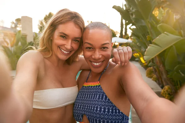 Twee Vrouwelijke Vrienden Bij Summer Pool Party Selfie Nemen Mobiele — Stockfoto