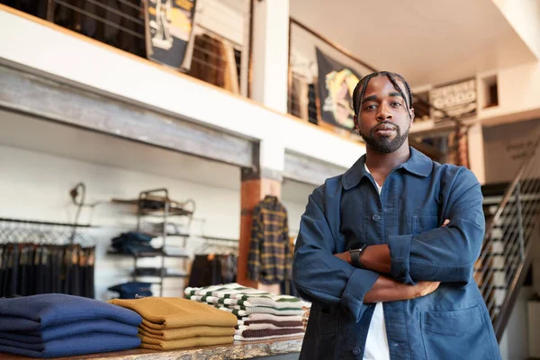 stock image Portrait Of Male Owner Of Fashion Store Standing In Front Of Clothing Display