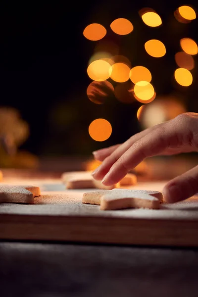 Womans Hand Reaches Freshly Baked Star Shaped Christmas Cookies Board — Stock Photo, Image