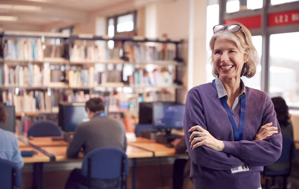 Portrait Mature Female Teacher Student Library Other Students Studying Background — Stock Photo, Image