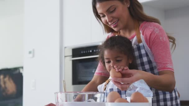 Hispanic Mother Daughter Cracking Eggs Bowl Having Fun Kitchen Baking — Stock Video