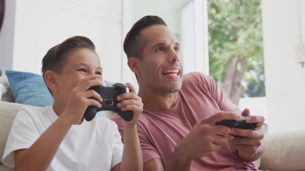 Hispanic Father Son Sitting Floor Home Playing Video Game Giving — Stock Video