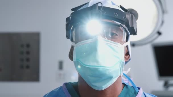 Πορτρέτο Του Ανδρός Χειρουργός Φορώντας Μάσκα Προστατευτικά Γυαλιά Και Φακό — Αρχείο Βίντεο