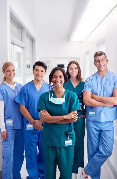 病院の廊下に立つ笑顔の多文化医療チームの肖像 — ストック写真