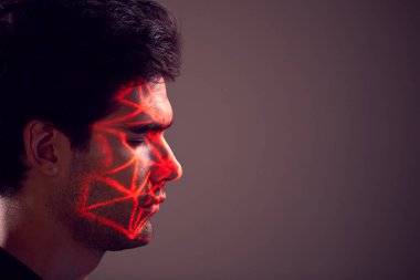 Facial Recognition Technology Concept As Man Has Red Grid Projected Onto Face In Studio clipart